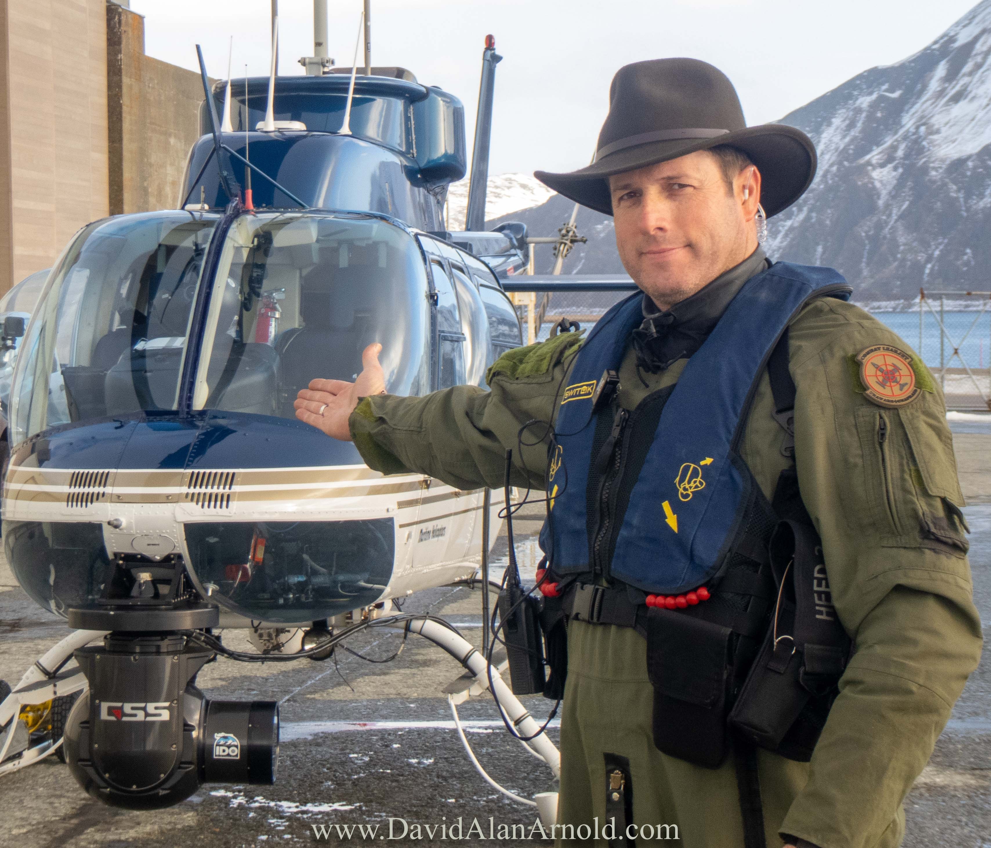 David Alan Arnold in flight suit standing beside helicopter at the dock, Deadliest Catch season 19